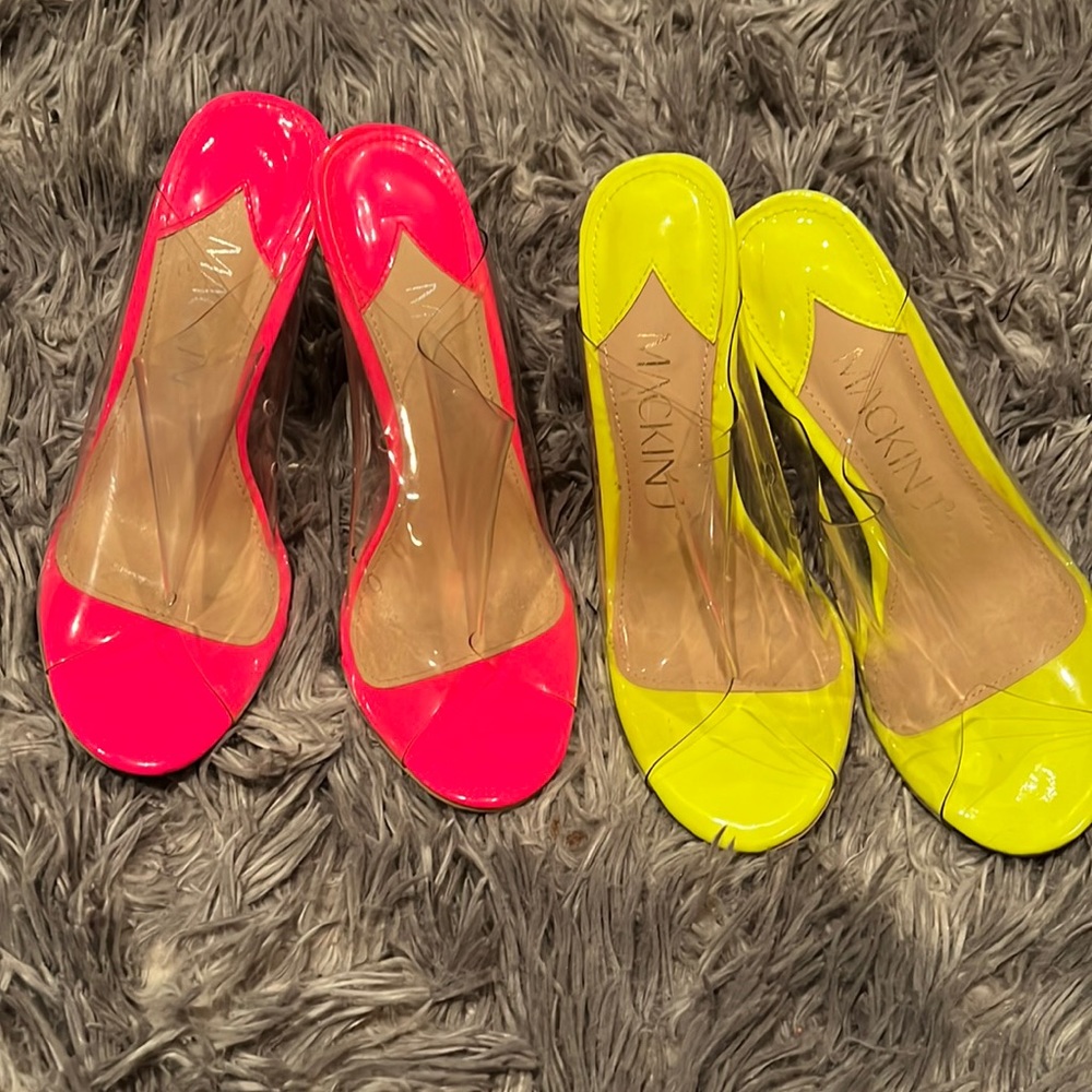 Two pair of wedge clear heels with a pop of color on the in soles of the sandal